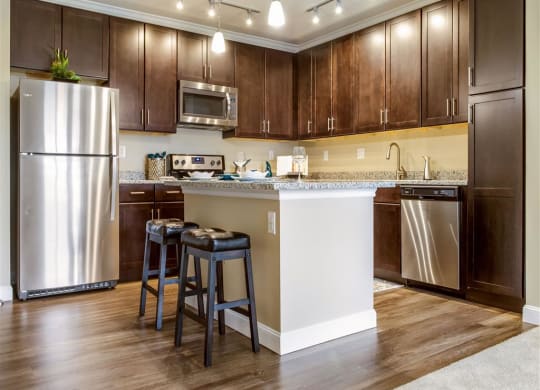Kitchen with wooden cabinets at The Oasis at Plainville, Plainville, 02762
