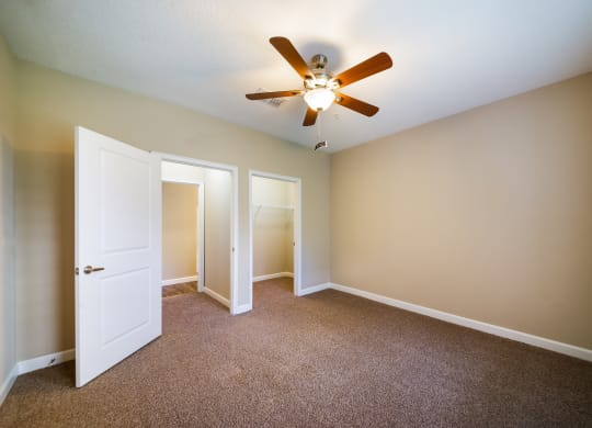 an empty room with a ceiling fan and a door to a closet at The Oasis at Highwoods Preserve, Florida, 33647