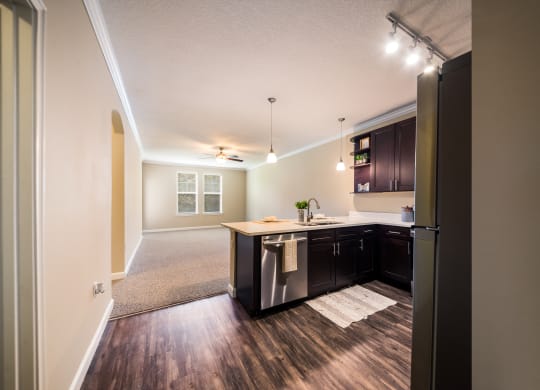 an open kitchen and living room with a refrigerator and a sink at The Oasis at Highwoods Preserve, Tampa, 33647