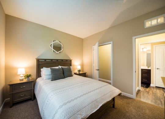 a bedroom with a large bed and a mirror at The Oasis at Highwoods Preserve, Tampa, FL
