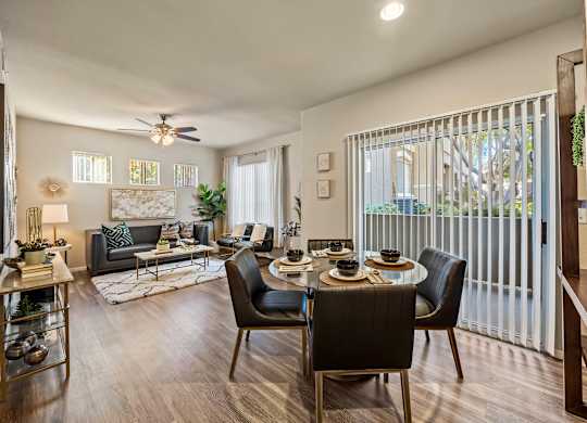 A modern living room with a dining table set for four.