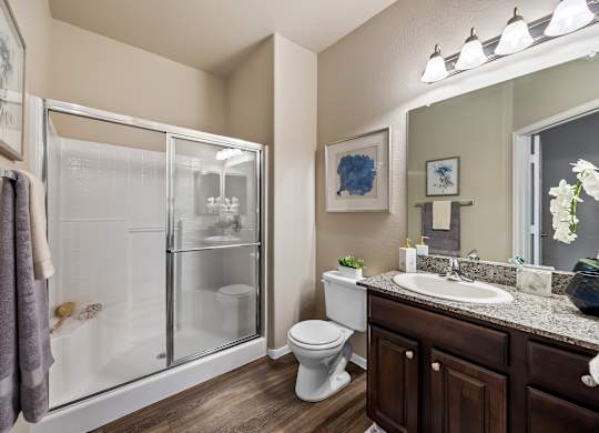 A bathroom with a toilet, sink, and shower.