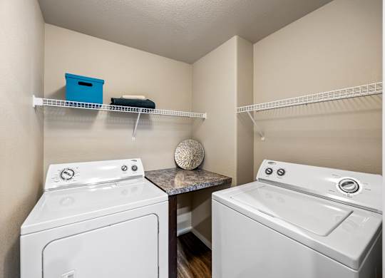 A small laundry room with a washer and dryer.