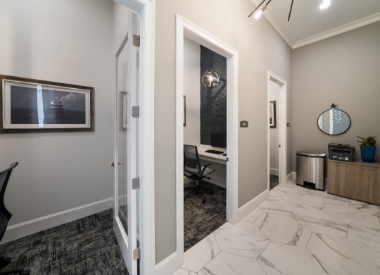 a corridor with a desk and a mirror in a home office  at The Oasis at Plymouth, Massachusetts