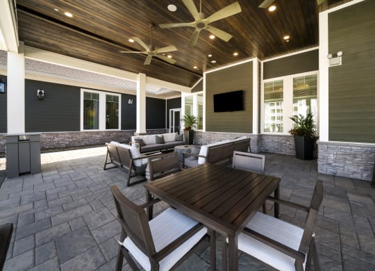 a covered patio with a table and chairs at The Oasis at Plymouth, Massachusetts