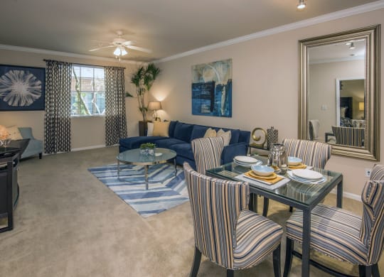 a living room with a couch and a table at Loreto & Palacio Apartments, Nevada 89149