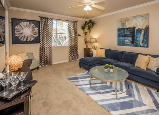 living room with a couch, coffee table and large rug at Loreto & Palacio Apartments, Las Vegas