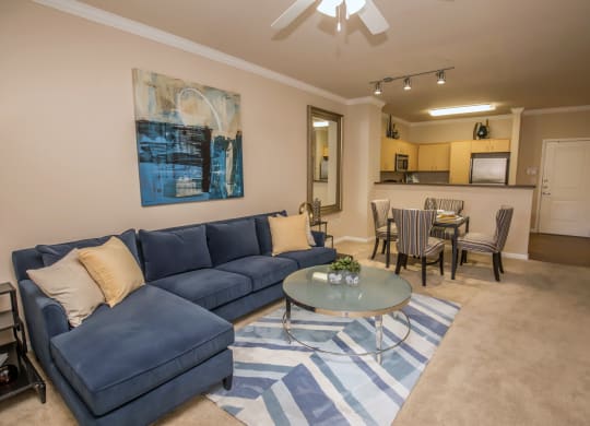 a living room with a blue couch and a coffee table at Loreto & Palacio Apartments, Las Vegas, NV