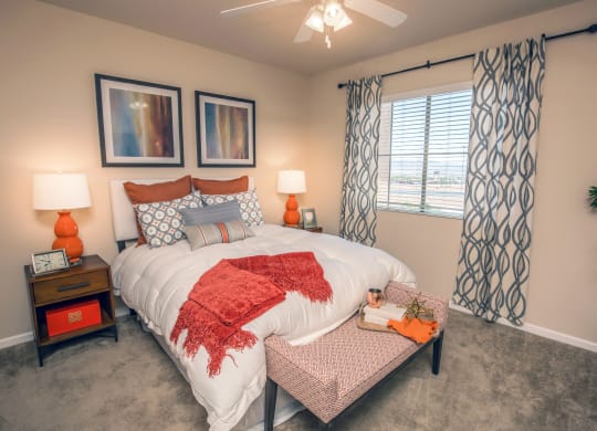 a bedroom with a large bed and a window at Loreto & Palacio Apartments, Las Vegas, Nevada