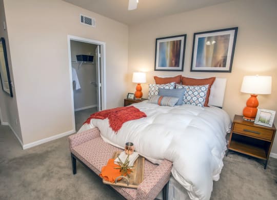 a bedroom with a bed and a chair and a closet at Loreto & Palacio Apartments, Las Vegas