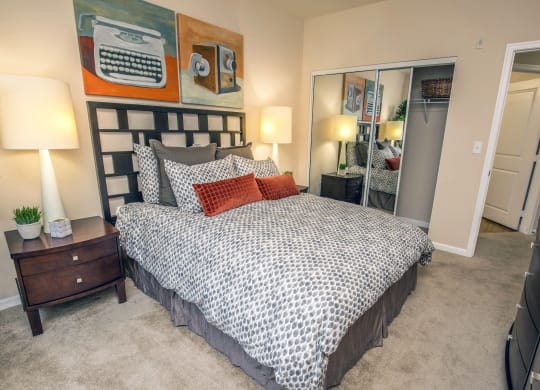 a bedroom with a bed and a mirror and a closet at Loreto & Palacio Apartments, Nevada