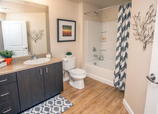 a bathroom with a shower toilet and sink and a mirror at Loreto & Palacio Apartments, Las Vegas, NV 89149