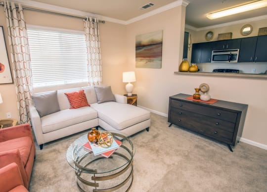 a living room with a couch and a table at Loreto & Palacio Apartments, Las Vegas, NV