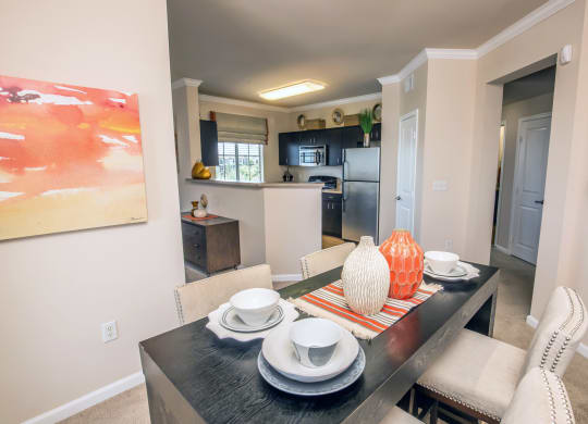 a dining room and kitchen with a table and chairs at Loreto & Palacio Apartments, Las Vegas, 89149