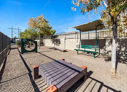 A playground with a slide, swings, and a seesaw.