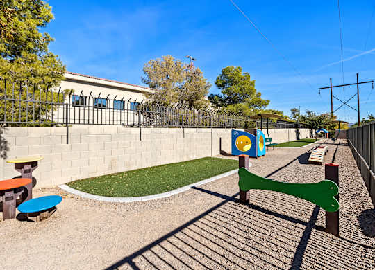 A playground with a green slide and a blue and yellow play structure.