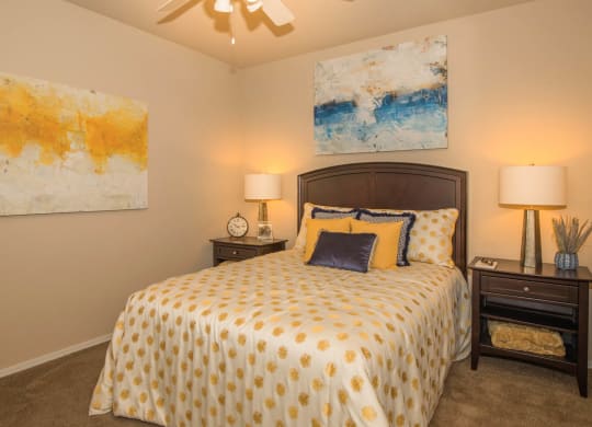 Bedroom with yellow light and frame at The Aliante by Picerne, Arizona