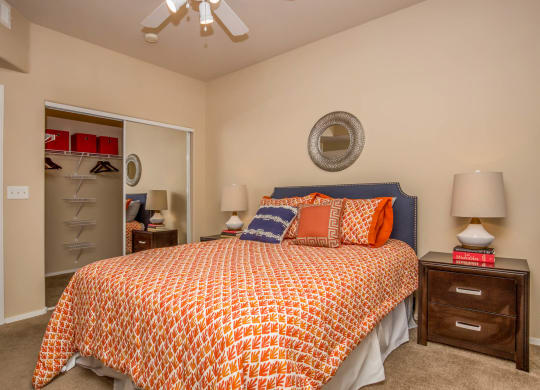 Bedroom with cozy bed and ceiling fan at The Belmont by Picerne, Las Vegas