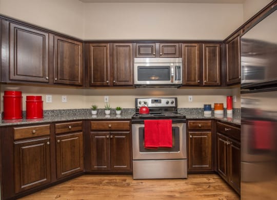 Kitchen space with wooden cabinets at The Belmont by Picerne, Las Vegas, NV, 89183