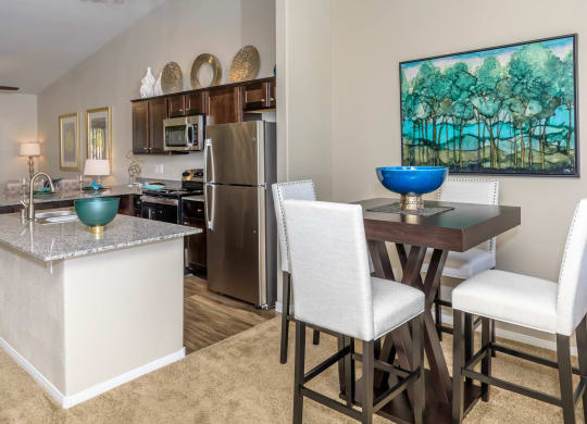 Kitchen wide view with cabinets and appliances with dining at The Cantera by Picerne, Las Vegas, NV, 89139