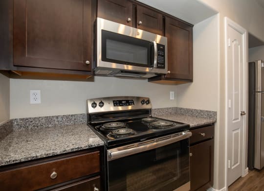 wooden cabinets and appliances in kitchen at The Cantera by Picerne, Las Vegas, NV, 89139
