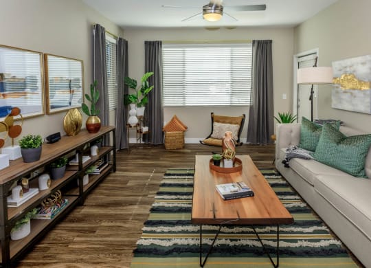 Living room decor with couch and frames along with center table at Level 25 at Sunset by Picerne, Las Vegas, 89113
