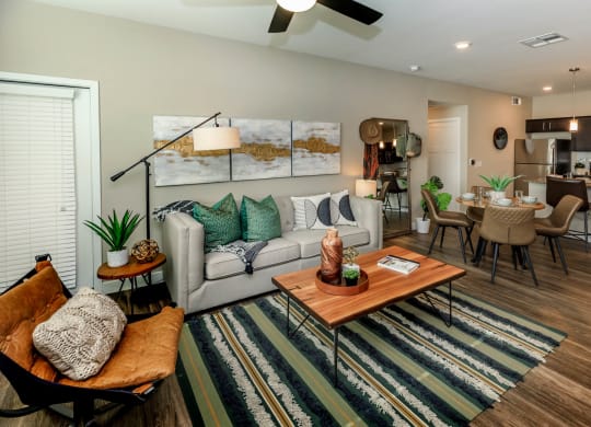 Living room decor with couch and frames at Level 25 at Sunset by Picerne, Las Vegas, NV