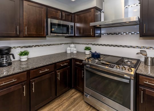 Kitchen with wooden cabinets at Level 25 at Sunset by Picerne, Nevada