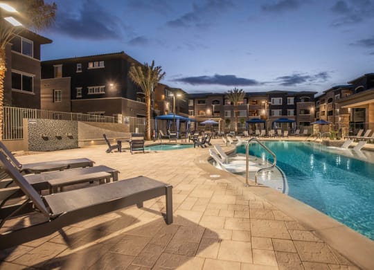 Pool view at night1 with building1 at Level 25 at Sunset by Picerne, Las Vegas