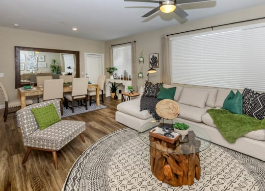 Living room with couch and wooden center tableat Level 25 at Sunset by Picerne, Nevada