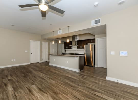 Wooden flooring living room and kitchen with dining space at Level 25 at Sunset by Picerne, Las Vegas, Nevada
