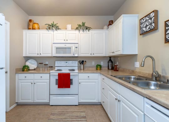 white appliances in kitchen at The Paseo by Picerne, Goodyear, AZ