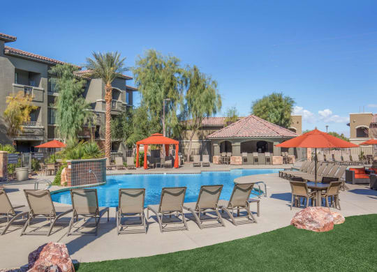 Swimming Pool With Lounge Chairs at The Passage Apartments by Picerne, Nevada