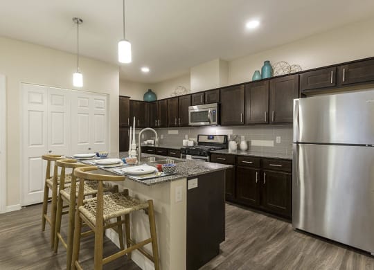 Kitchen with wooden cabinets and breakfast bar at The View at Horizon Ridge, Nevada, 89012