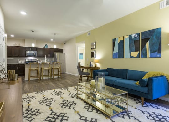 Living room with tv and couch and model kitchen at The View at Horizon Ridge, Henderson
