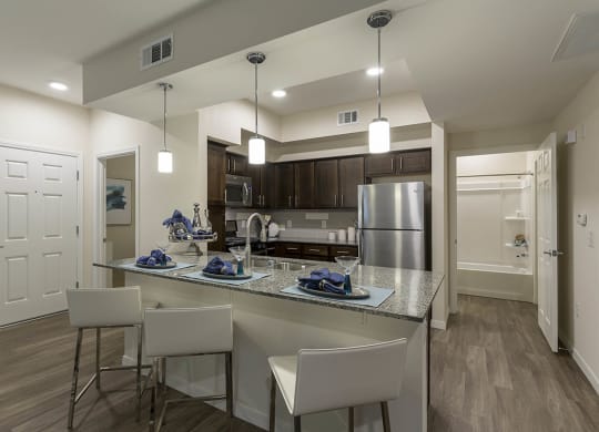 Wooden cabinets in kitchen with breakfast bar at The View at Horizon Ridge, Henderson, Nevada