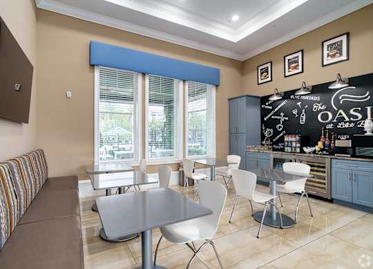 A modern kitchen with a dining table and chairs.