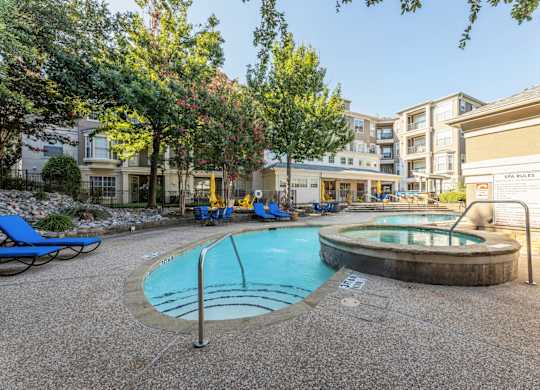 Our community swimming pool with stairway into pool at Encore at Buckingham apartments in Richardson, TX