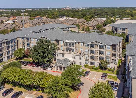 An aerial view of Encore at Buckingham apartments entry showcasing apartment patios and balconies, in Richardson, TX