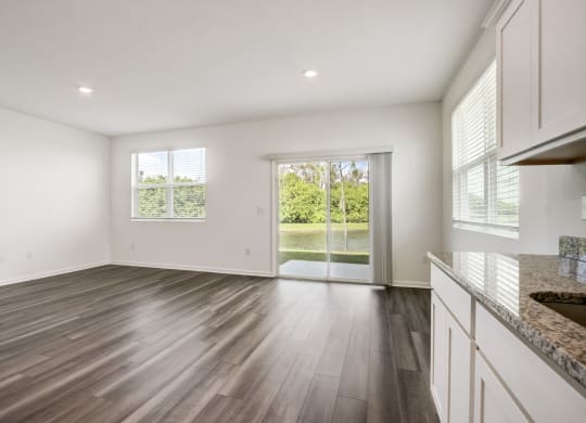 Spacious living area connected to the backyard at Beacon at Arbours in Ruskin, FL