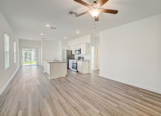 View of the kitchen from the living room in the Oak floor plan at Beacon at Clinton Corners in Dade City, FL