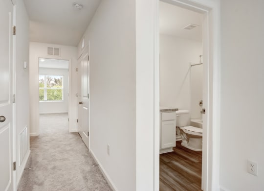 Upstairs hallway leading from master to the other two bedrooms and second full bathroom at Beacon at Arbours in Ruskin, FL