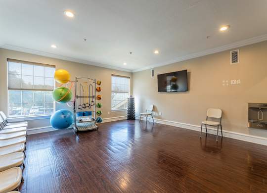 Fitness center yoga and core area with water fountain and tv at Encore at Buckingham apartments in Richardson, TX