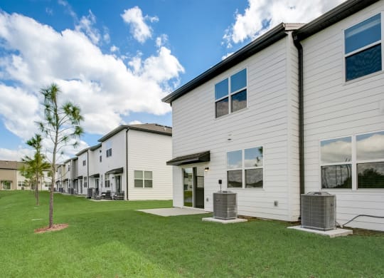 View behind the townhomes of the open yard area at Beacon at Arbours in Ruskin, FL