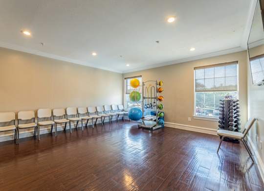 Exercise and core room in fitness center with folding chairs, medicine balls, and other equipment at Encore at Buckingham apartments in Richardson, TX