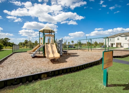 Children's playground with modern equipment at Beacon at Arbours in Ruskin, FL