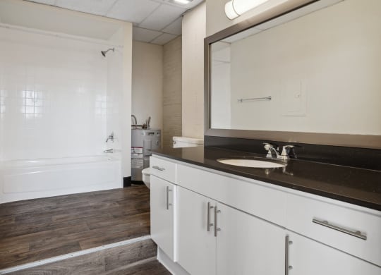 3200 Main Lofts bathroom with large vanity and step up to shower | Deep Ellum Lofts in Dallas, TX