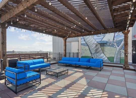 Rooftop patio with blue couches at 3200 Main Lofts | Deep Ellum Lofts in Dallas, TX