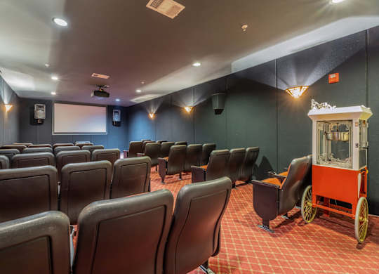 35-seat theater room with a projector and popcorn maker cart at Encore at Buckingham apartments in Richardson, TX