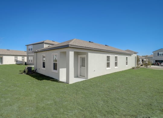 Side view of Elm floor plan house from the backyard at Beacon at Clinton Corners in Dade City, FL